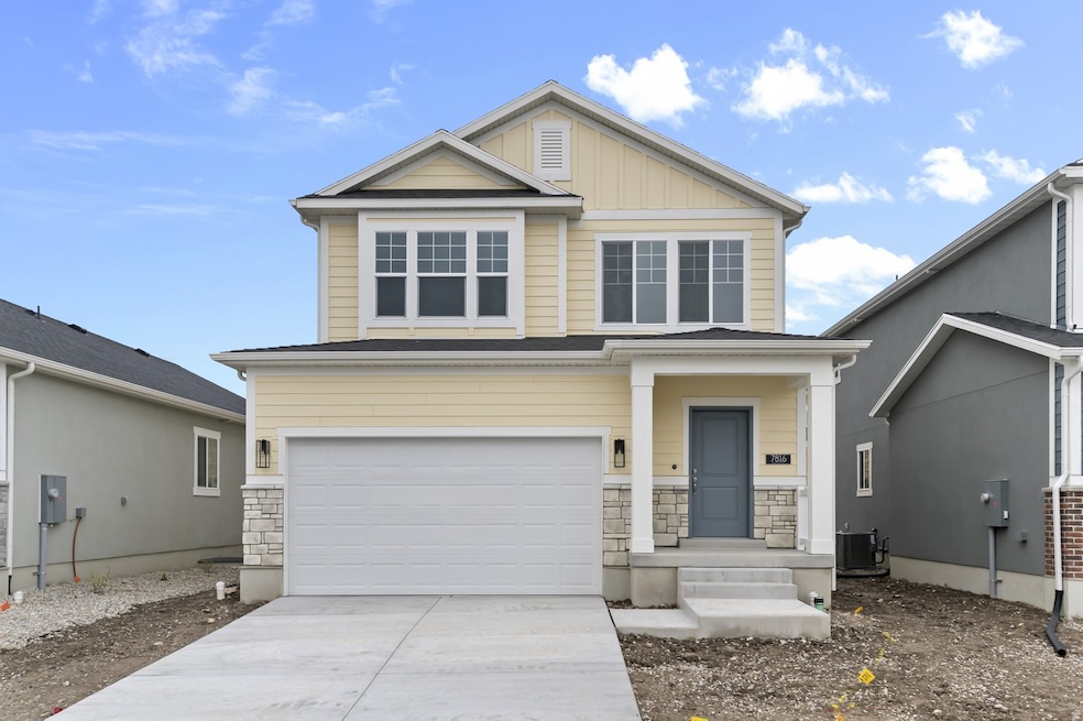View of front of property with stone siding, an attached garage, concrete driveway, and board and batten siding