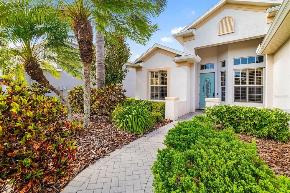 Lush tropical landscaping brick paver walkway leading to the entrance  12211 Lavender Loop, Bradenton, FL 34212