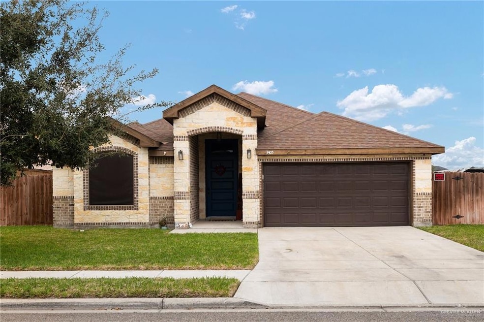 View of front of house featuring a garage and a front lawn