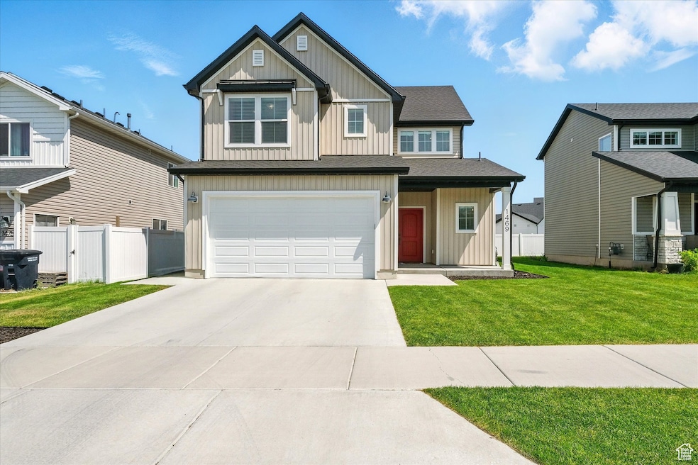 Craftsman inspired home with board and batten siding, a garage, and concrete driveway