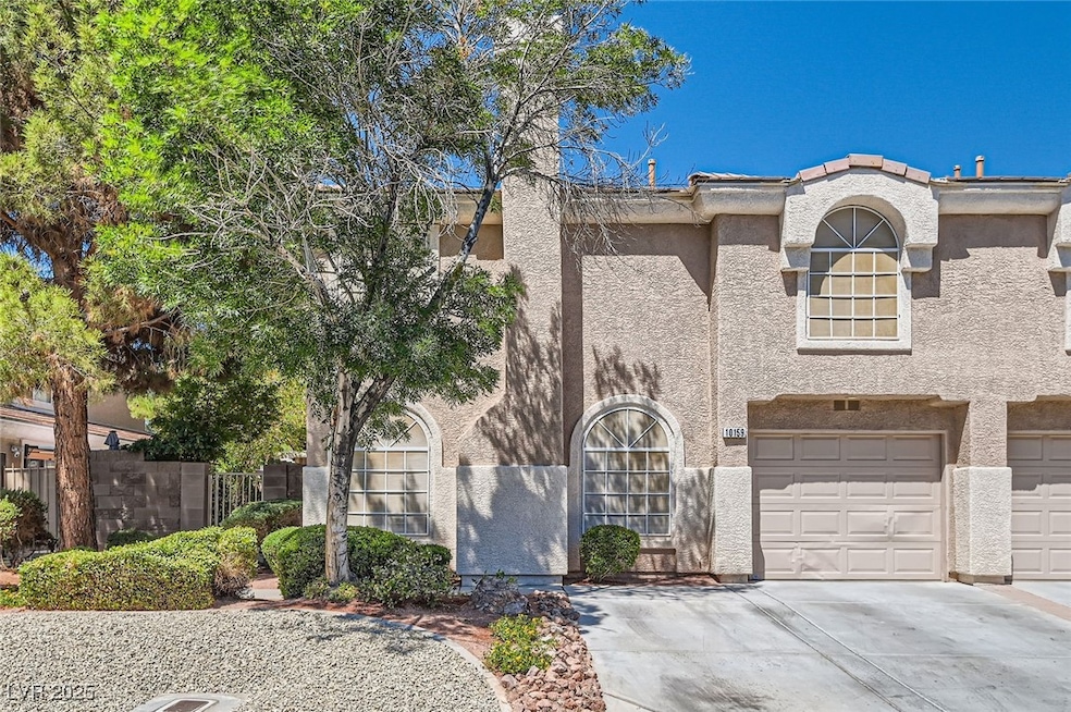 View of front of home with driveway, stucco siding