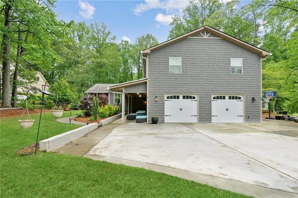 View of side of home featuring driveway, a lawn, a