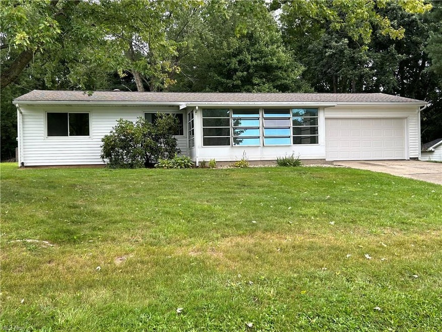 Single story home featuring a front yard and garag