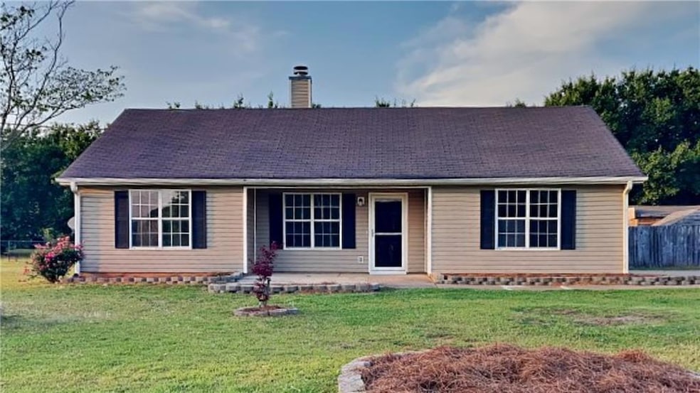 Ranch-style home featuring fence, a chimney, and a