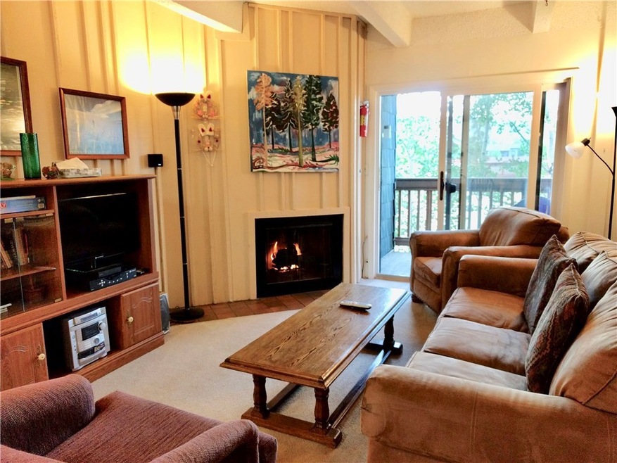 Bright and open living area with gas fireplace.