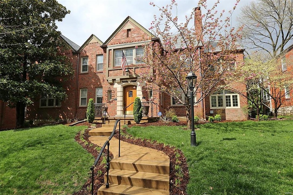 Front exterior with professional landscaping inclu
