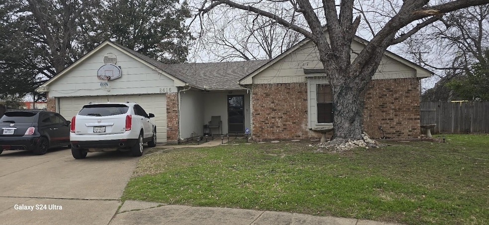 Ranch-style house with a garage and a front yard