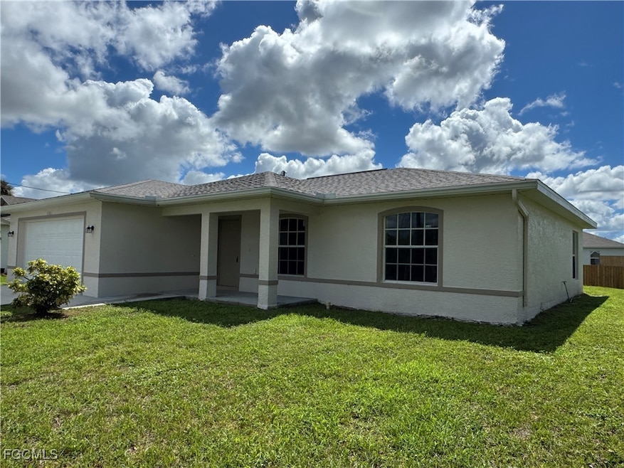 Single story home with a garage, stucco siding, a patio area, and roof with shingles