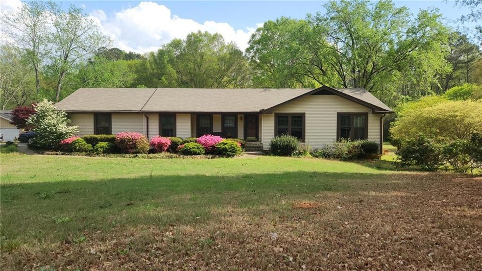 Ranch-style house featuring a front lawn