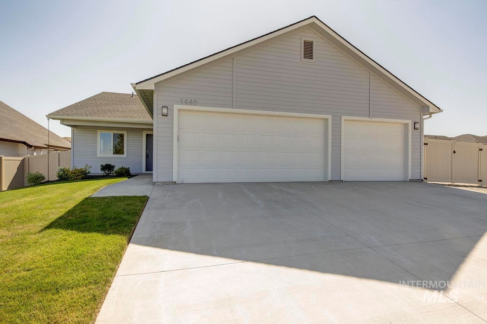 Ranch-style house featuring concrete driveway, a garage, and a gate