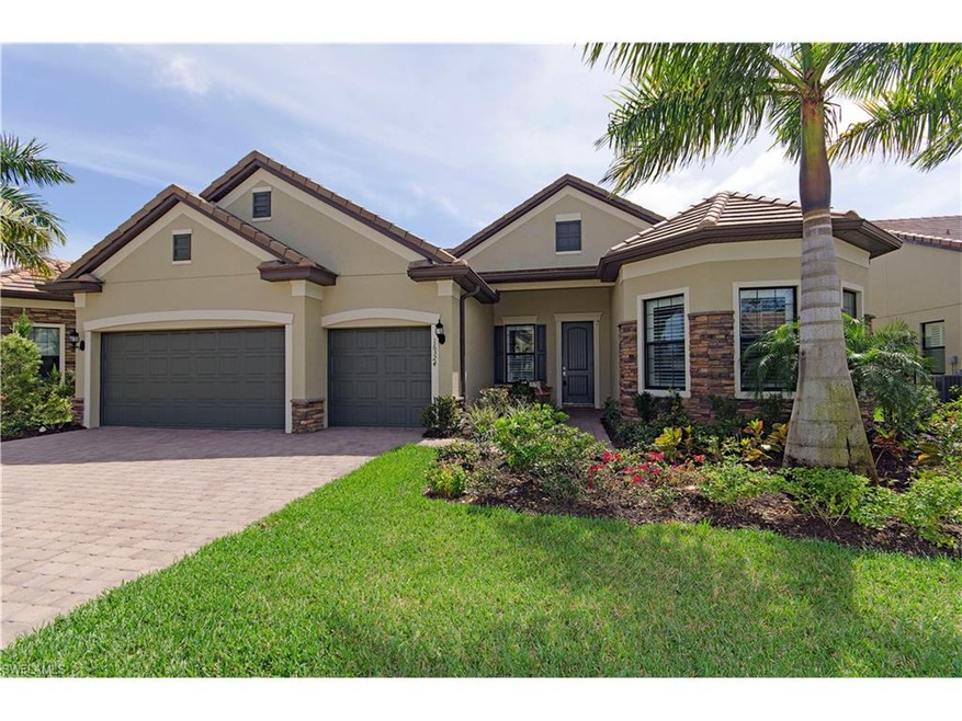 Front photo of home.  Nicely landscaped, stone and stucco entry, quaint walk way with room for outdoor seating, 3 car garage---very rare for this price point!!