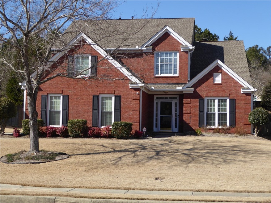 Exquisite brick front on beautiful level lot. Side