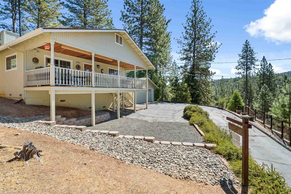 Rear view of property featuring covered porch