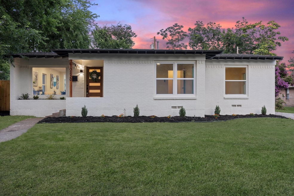 View of front of property with brick siding, a front lawn, and crawl space
