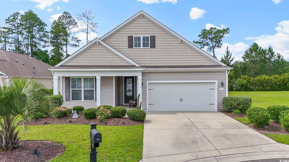 View of front of house featuring driveway, a front lawn, a porch, and an attached garage