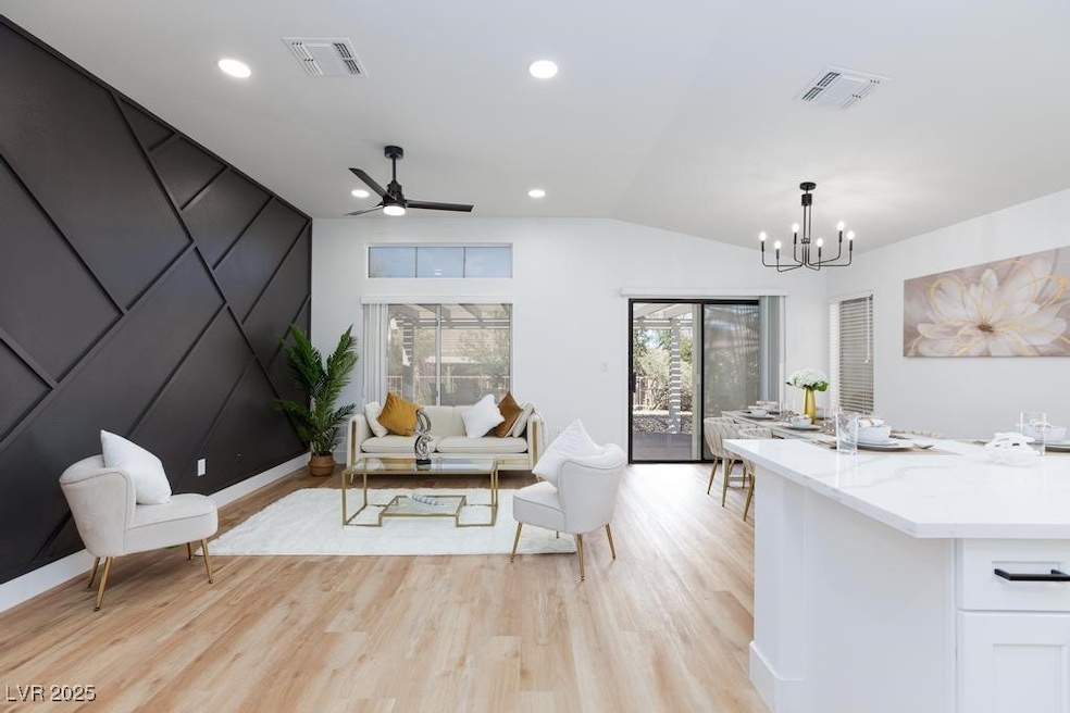 Living area featuring a chandelier, light wood-sty