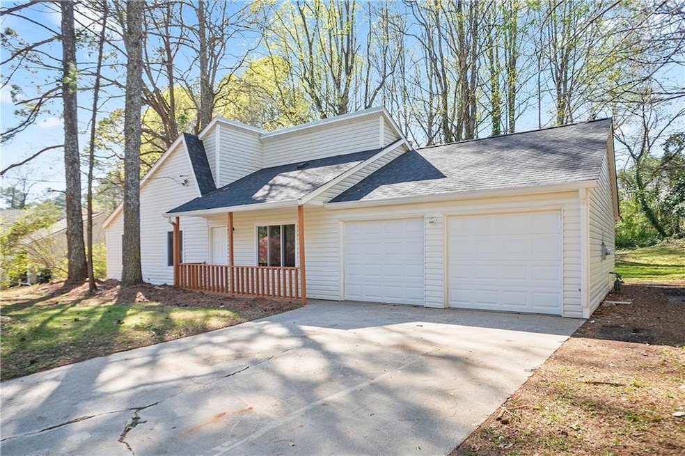 View of side of property featuring driveway, a shi