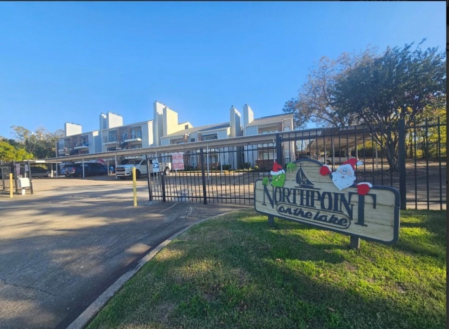 View of community featuring covered parking
