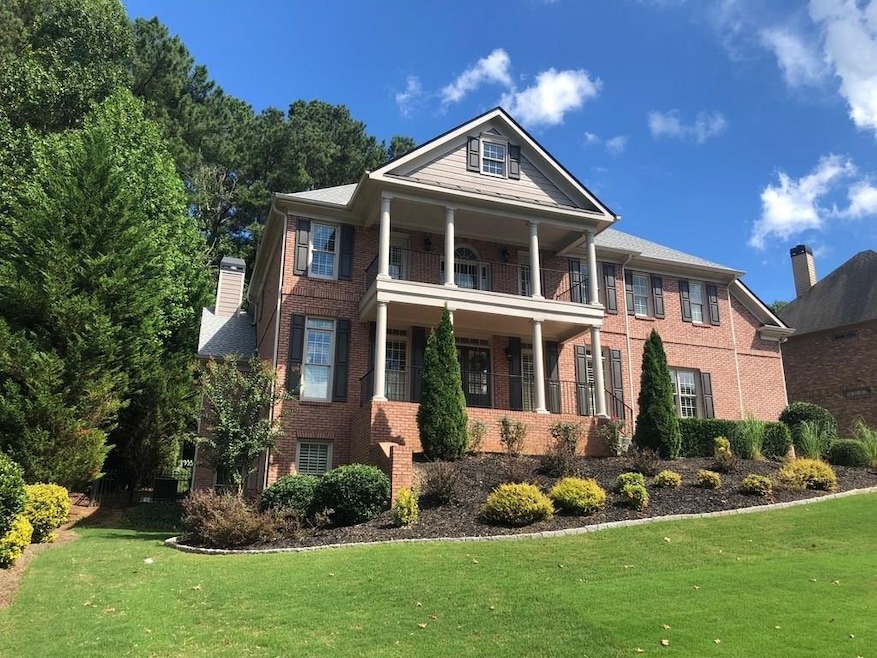 Gorgeous 3 sides brick home features a rocking cha