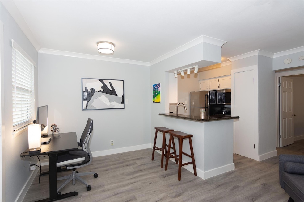 Office area featuring light wood finished floors 