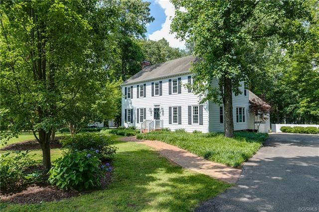 This home features a large, flat lot, mature lands