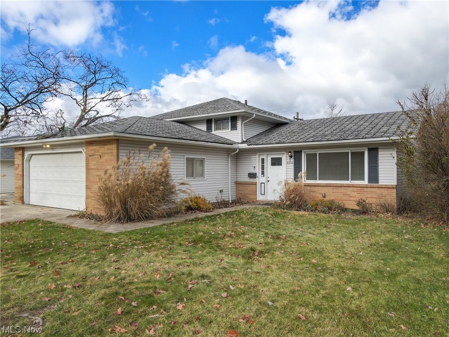 View of front of property with a front yard and a garage