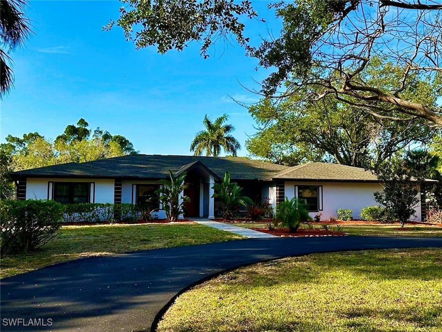 Ranch-style house with a front yard and stucco sid