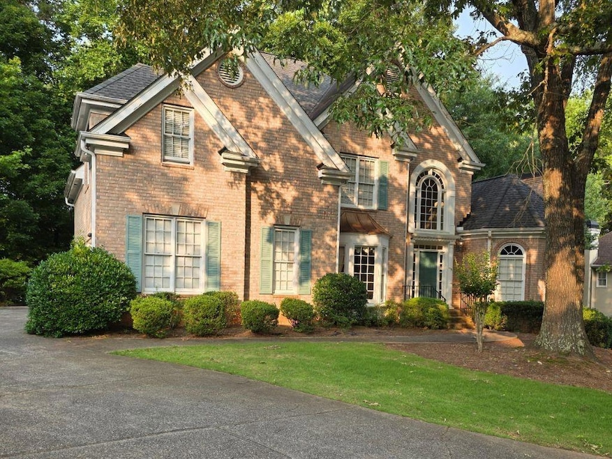 View of front of property with brick siding and a front lawn