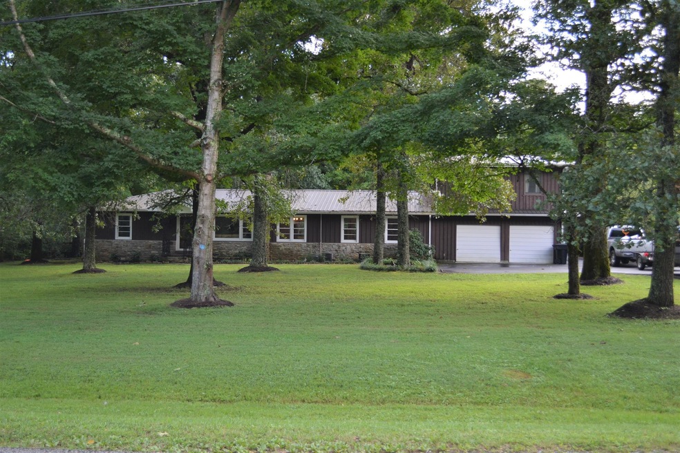 Welcome Home! This home offers a lot of space, both inside and out! Hardwood flooring, tile flooring, fresh paint, storage galore, oversized garage, metal roof and more!