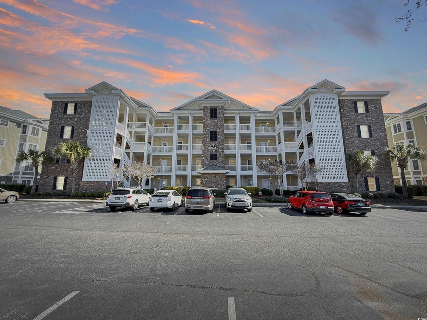 View of property featuring uncovered parking