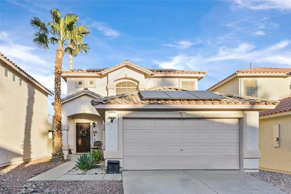 Mediterranean / spanish-style home featuring a gar