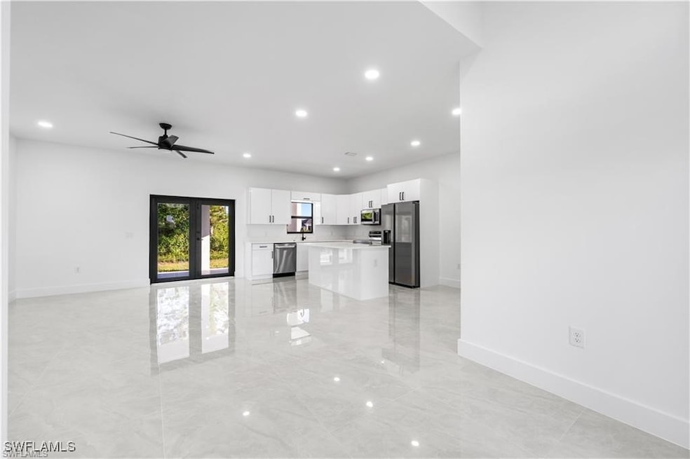 Unfurnished living room featuring french doors and