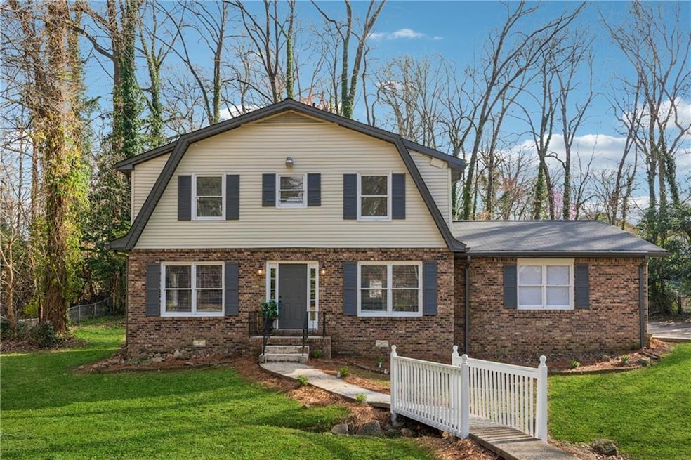 View of front of home featuring brick siding, a ga