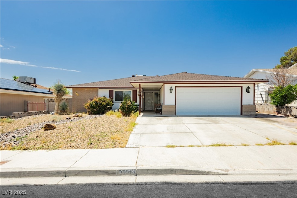 Ranch-style home with an attached garage, brick si