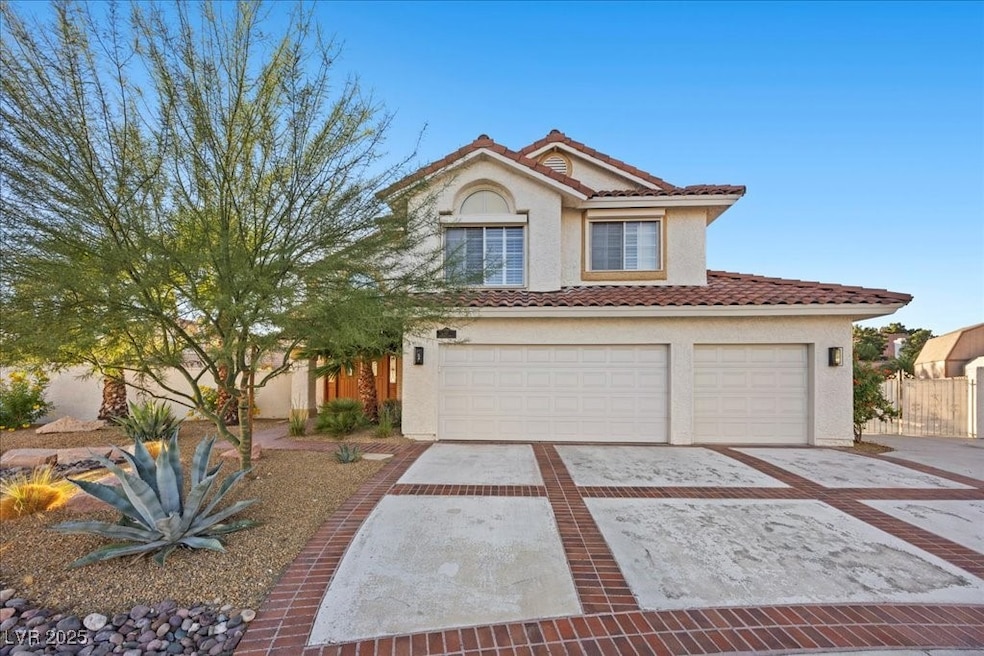 Mediterranean / spanish home with stucco siding, concrete driveway, an attached garage, and a tiled roof