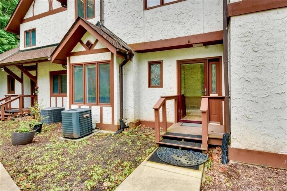 Doorway to property featuring stucco siding