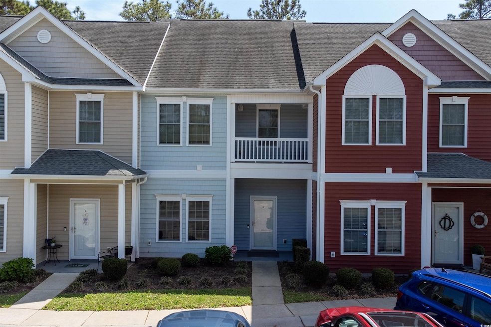 Townhome / multi-family property with roof with sh