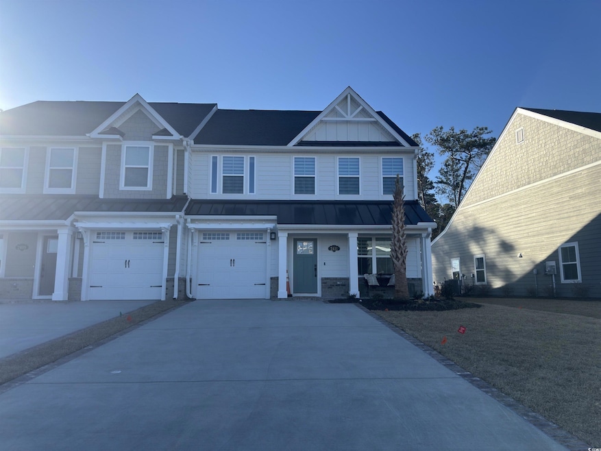 View of front facade with concrete driveway, board