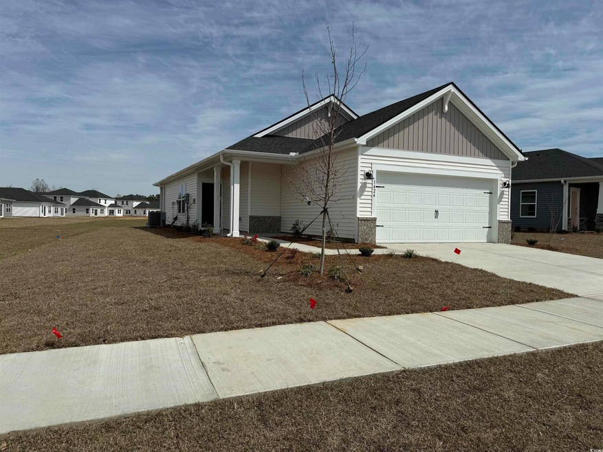 View of front of house featuring driveway, a garag