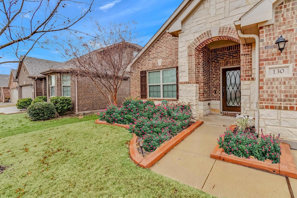 View of the front (Spring flowers) with nice front porch entry.