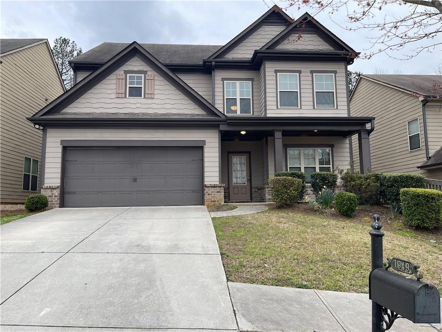 Craftsman-style home featuring a front lawn, a por