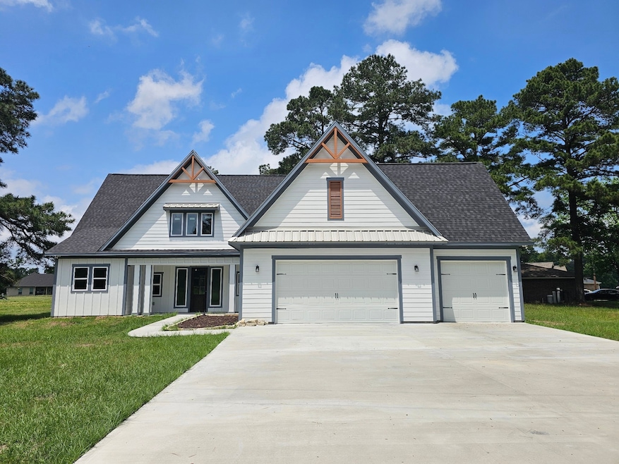 Modern farmhouse with a three-car garage, a charmi