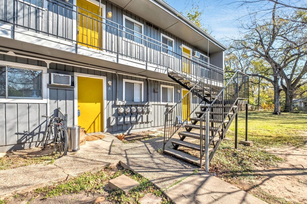 View of community with stairway and a lawn