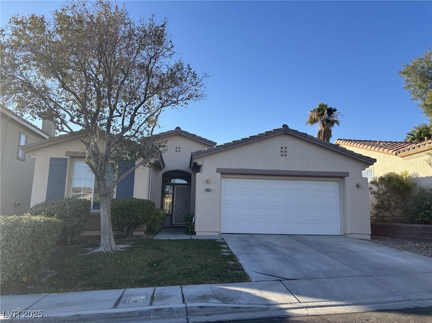 Single story home with stucco siding, a garage, an