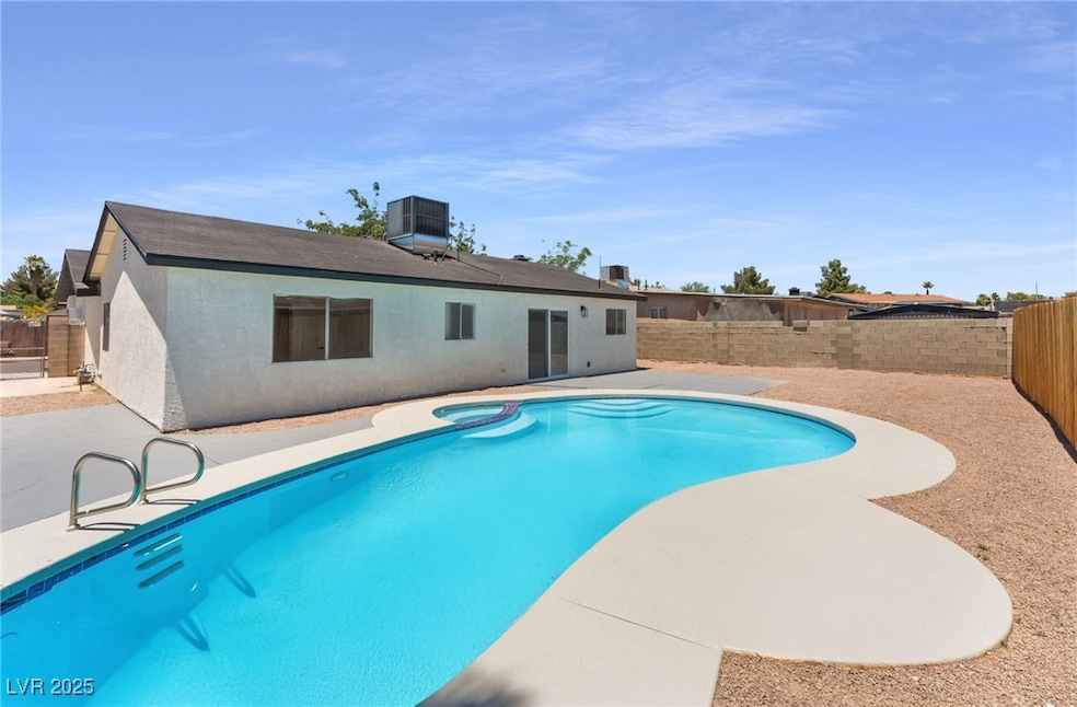 View of swimming pool with a fenced backyard, a pa