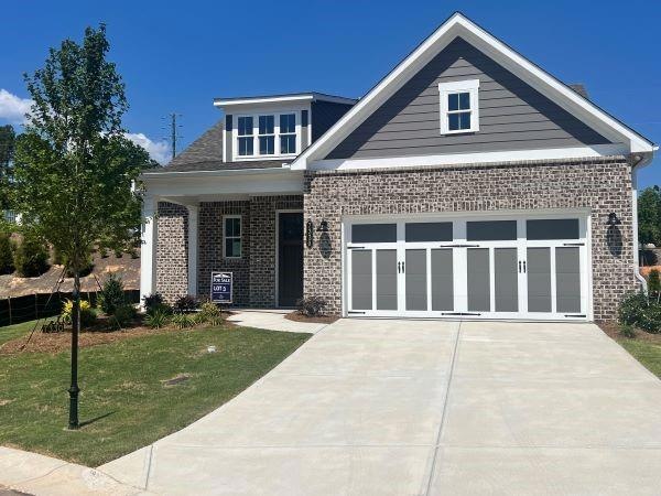 Craftsman-style home featuring a garage and a fron
