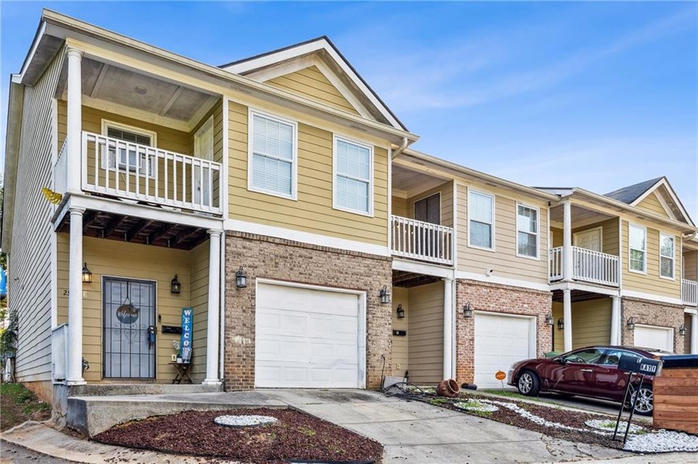 View of property featuring a balcony and a garage