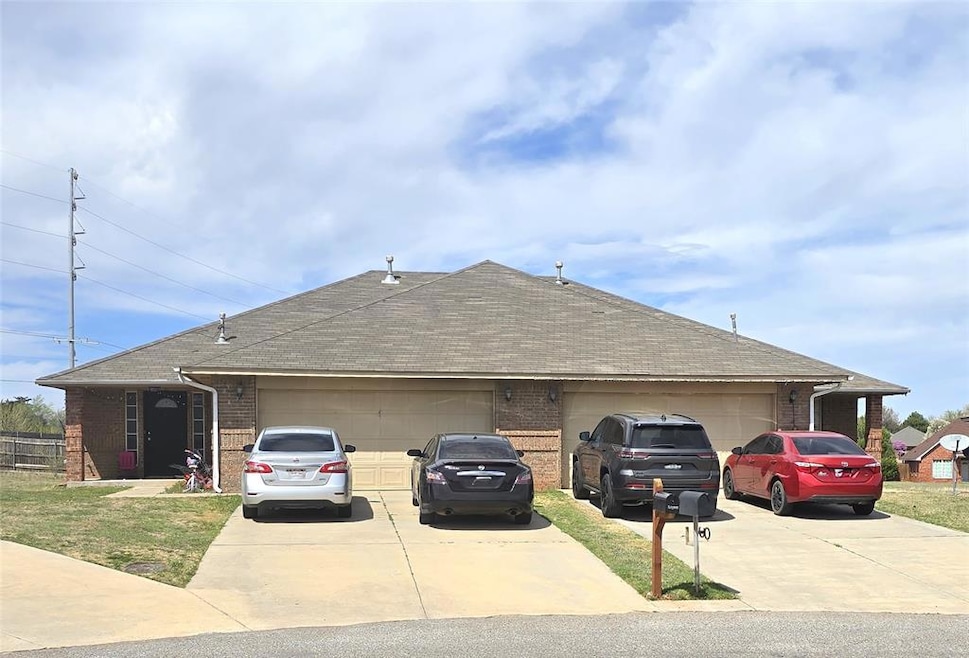 View of front of house featuring brick siding, dri