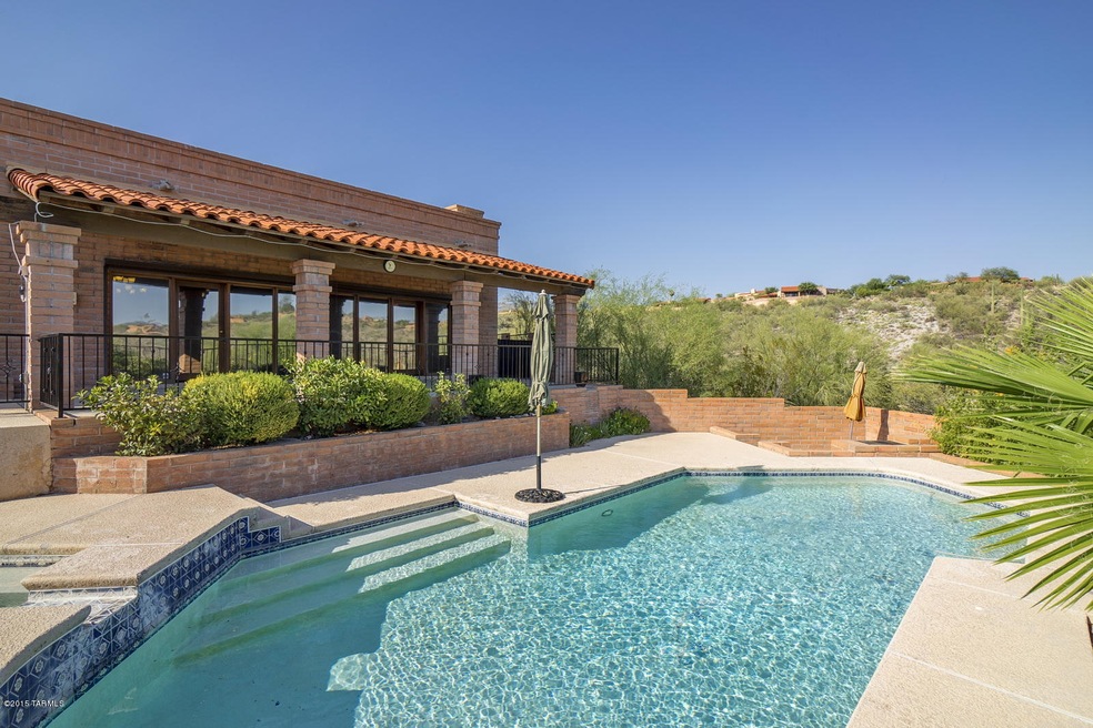 Huge covered patio overlooking cool pool