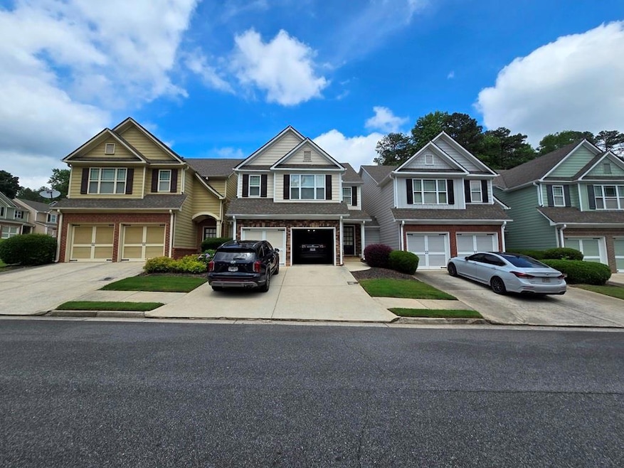 View of front of property featuring a garage, driveway, and a residential view